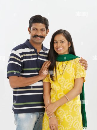 couple-standing-together-and-smiling-W9YDG