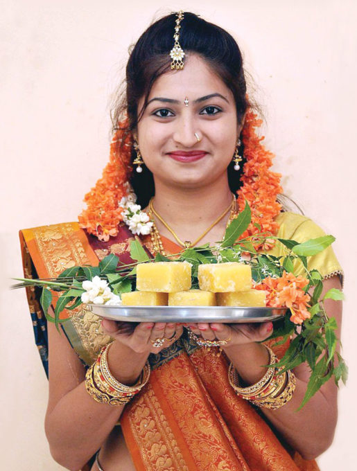 a-model-wearing-traditional-dress-holds-a-plate-173118