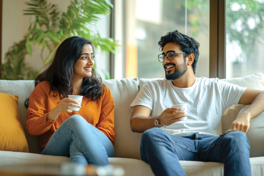 man-woman-are-sitting-couch-smiling