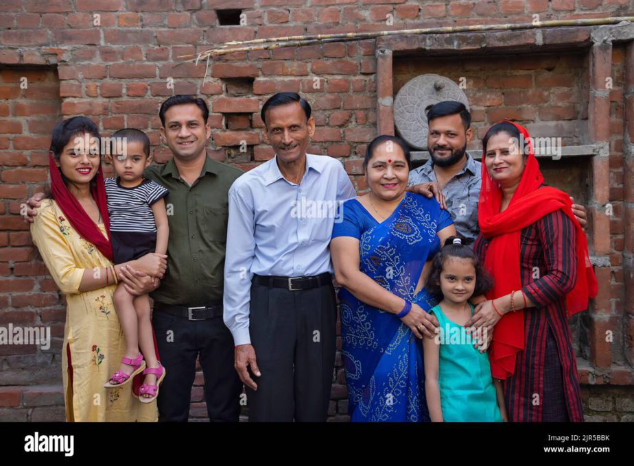 portrait-of-lower-middle-class-family-standing-together-in-the-backyard-2JR5BBK