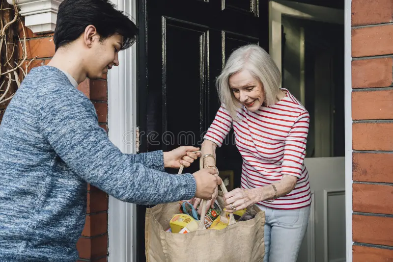 delivering-groceries-to-elderly-teenage-boy-some-woman-handing-her-shopping-bag-her-front-door-92302624