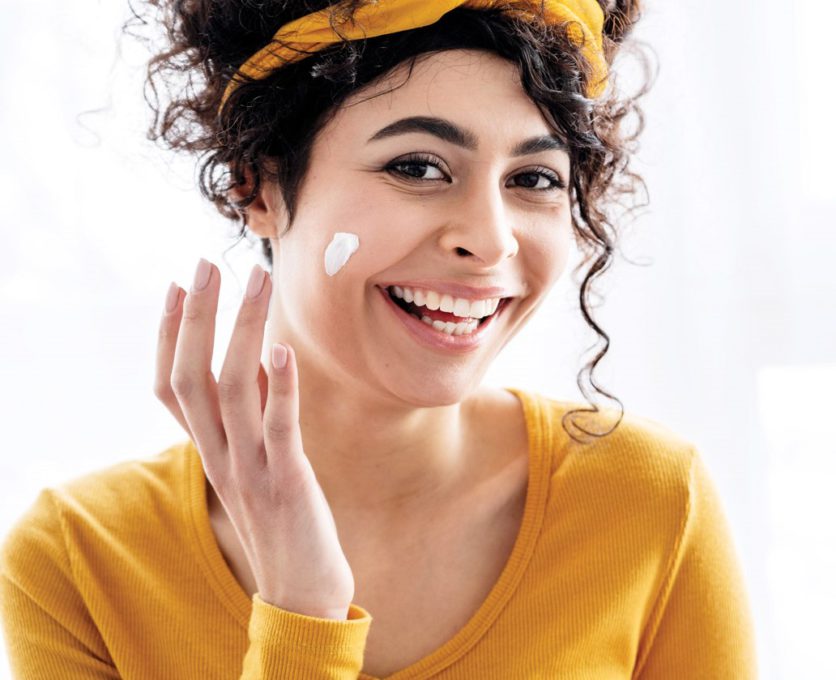 portrait-happy-woman-laughing-playing-with-moisturizer-with-copy-space
